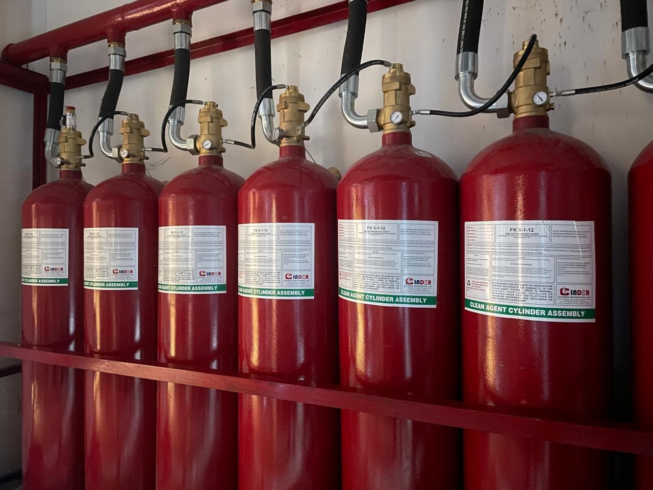 Close view of clean-agent cylinders connected to a common discharge manifold