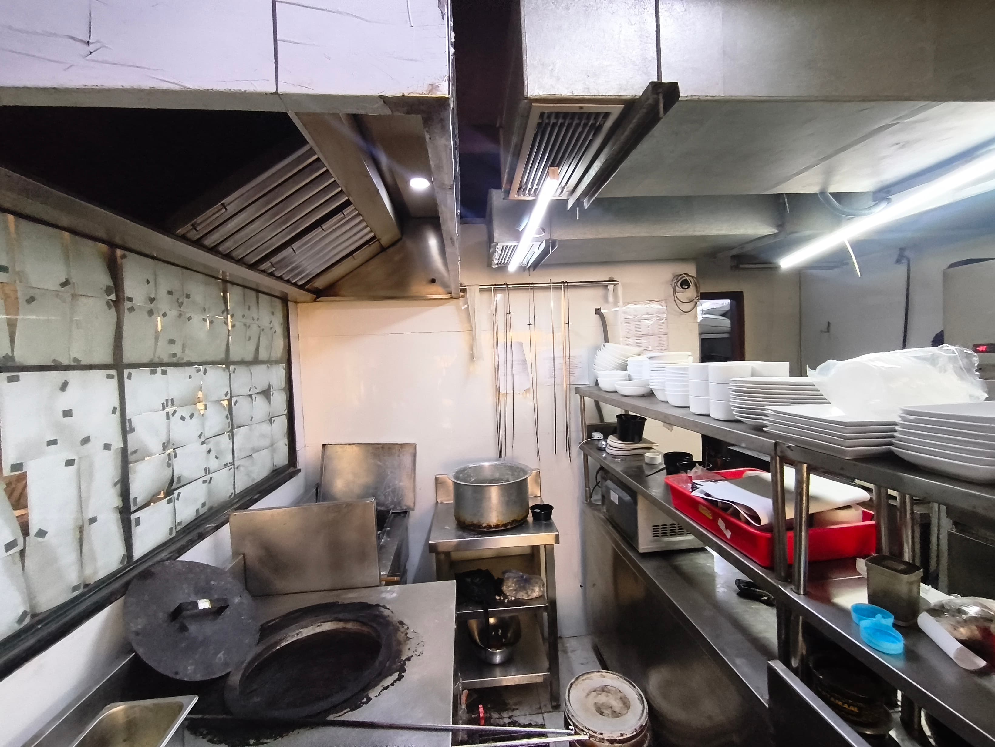 Wide view of a commercial kitchen prepared for a suppression installation
