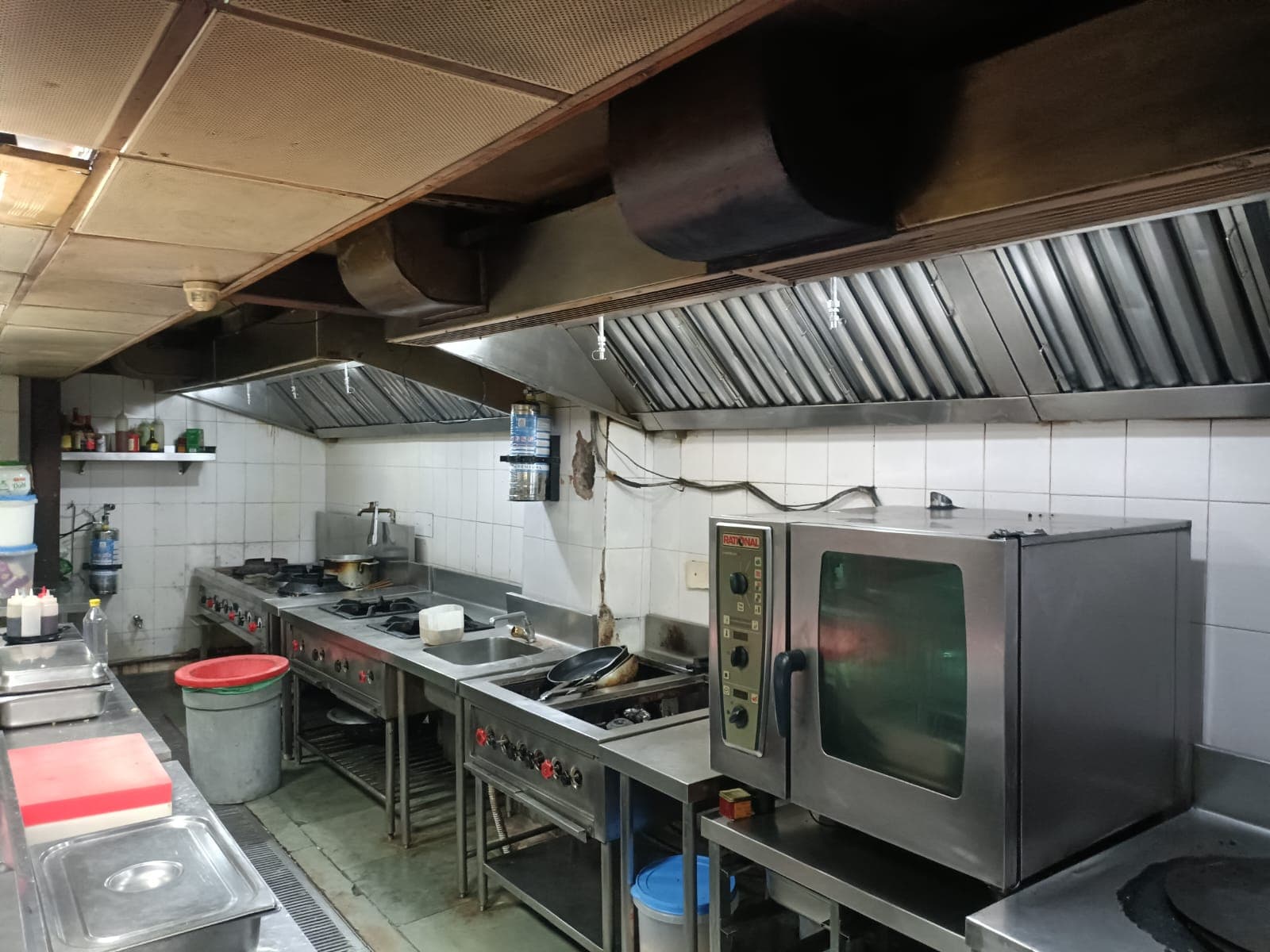 Kitchen suppression cylinders mounted below stainless extraction hoods