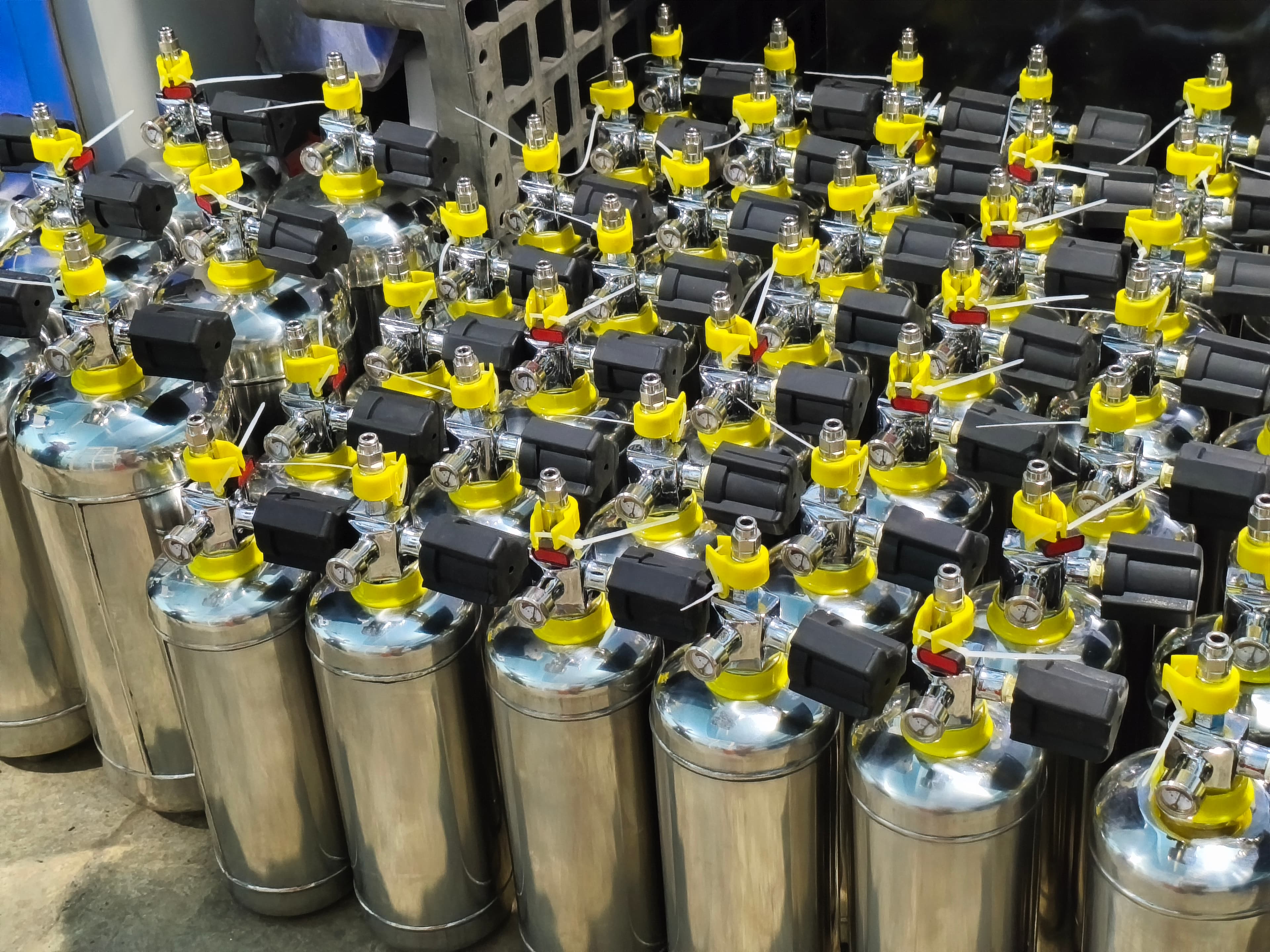 Rows of finished stainless steel suppression units with their valves and actuators fitted