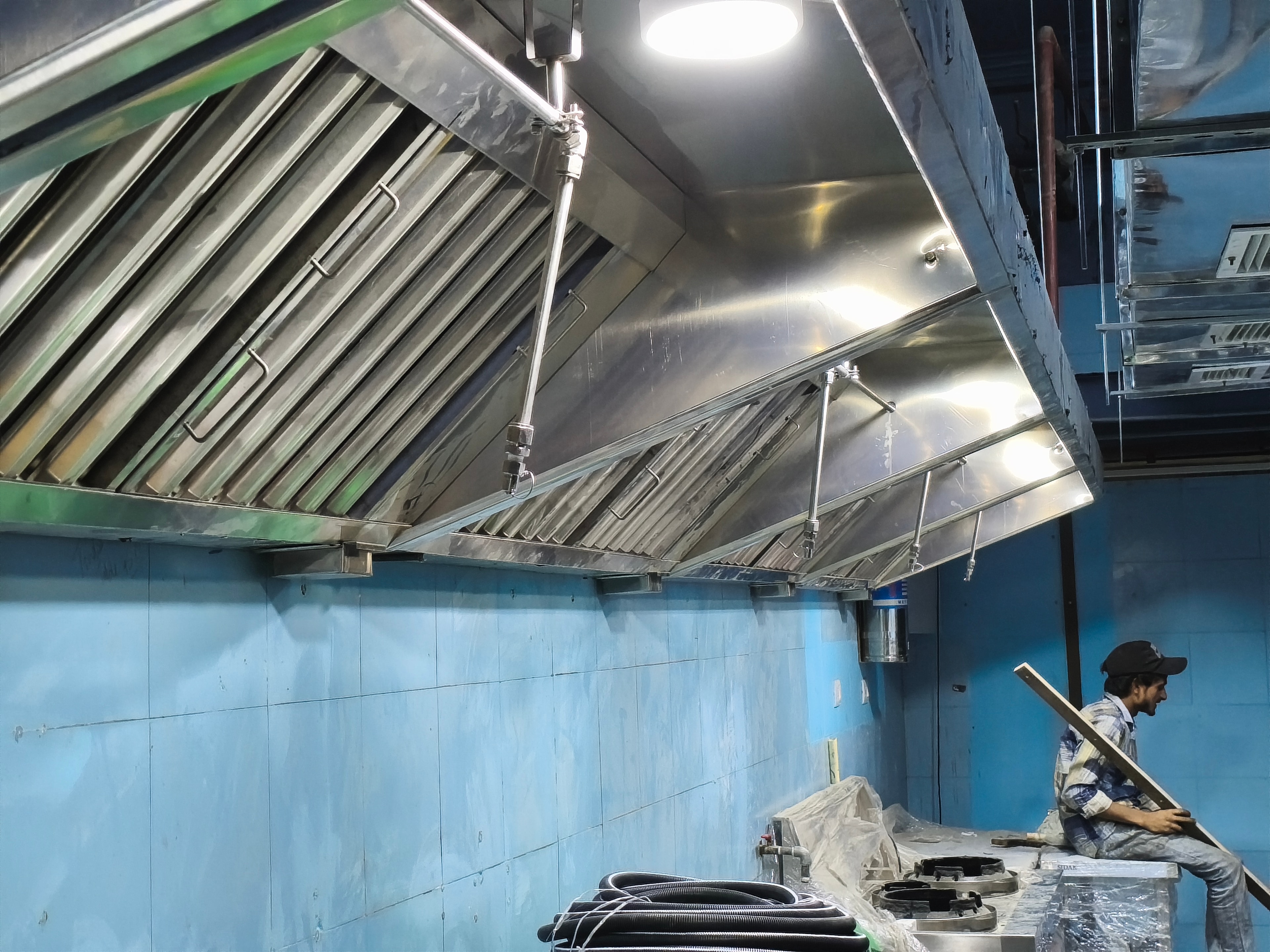 Suppression pipework and nozzles installed above a commercial kitchen line